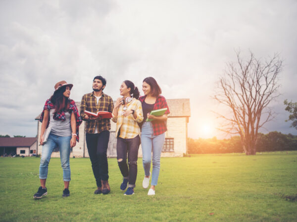 group-student-walking-through-park-after-class-enjoy-talking-together (1)